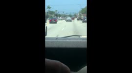 Men chase car through the city after having attacked it trying to smash windows at a red light.