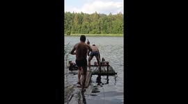 Friends Playfully Push Each Other Into Water
