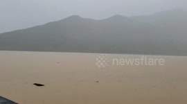 Linear rainband brings torrential rains, causing severe flooding in Japan's Amami Region