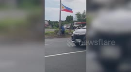 Old tuk-tuk driver sets up flag along road before giving it salute days before Independence Day