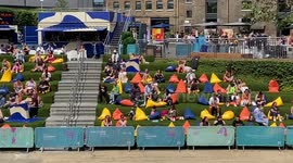 Crowds soak up the sun next to giant “melting ice lollies” in King’s Cross