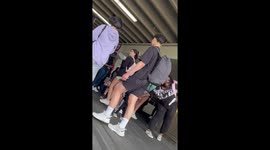 A lady runs on board a plane after. Being denied seats and leaves her children at the gate be in bang watches by her other cell phone