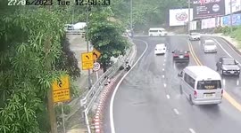 Car slides down mountain road during rainstorm on Thai island