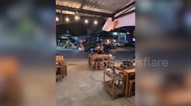 Pickup truck with broken-down trailer splutters across busy road