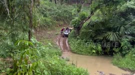 Tourist flies over ATV quad bike handlebars landing into muddy puddle