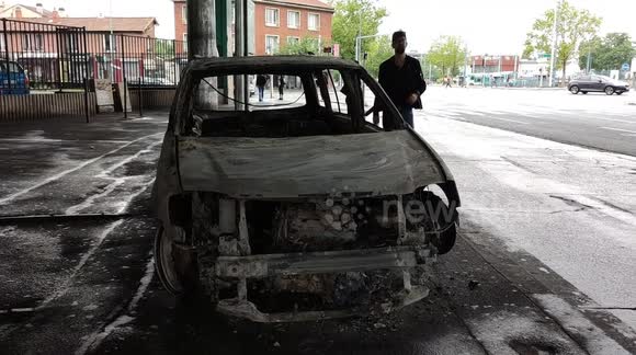 Paris morning scene: cleanup begins at shop looted after another night of riots