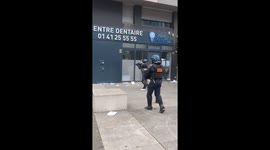 A police officer aims at a demonstrator with an LBD rifle, in Nanterre (France).
