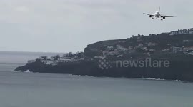 Plane bails out of landing at the last second due to heavy cross winds