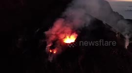 Bright, hot lava sprays out of an erupting volcano’s mouth in Italy
