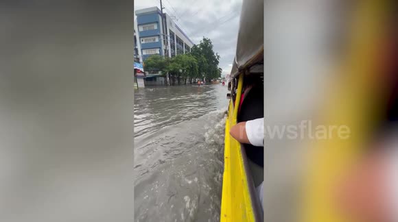 Passing bus speeds through flooded road drenching jeepney passengers in ...