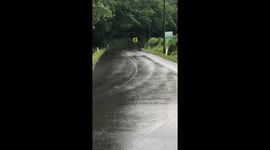 Cyclist Slides On Slippery Street