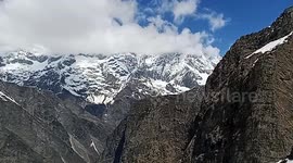 Video begins with sweeping shots of a snow-capped mountain Cut to scenes of Lily leading a group of tourists up the mountain.