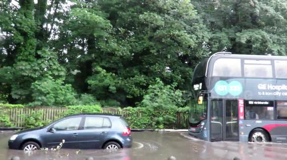 Cars are flooded and drivers use cycle lanes as severe flooding hits Birmingham, England as persistent torrential rain lashes the city.