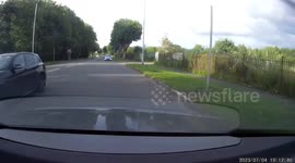 Motorcyclist performs a wheely on the road caught on dash cam