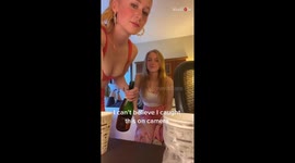 Girl drinking champagne straight from the bottles chokes on it and spews it out