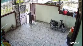 Close call: son narrowly escapes door mishap as mother leaves on motorbike