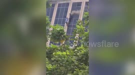 Man's terrifying plunge from the third floor as inferno engulfs shopping mall!