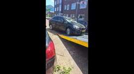 Aftermath of a storm that sent a tree crashing down on car *Storm Damage*