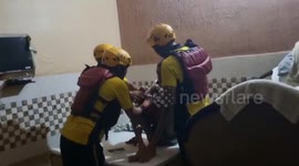Rescue officials come to the aid of handicapped man trapped in waterlogged house in northern India