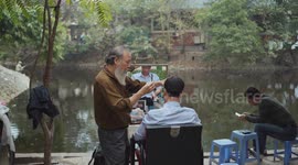 Stockshots of Street barber in Hanoi, Vietnam