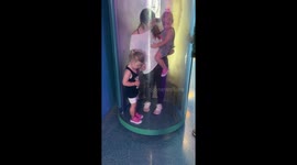 Sisters take their turn inside the hurricane simulation chamber *Hilarious Reaction*