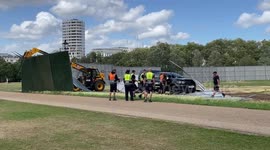 Strong wind blows down a festival fence which damages a pickup truck in Hyde Park, London
