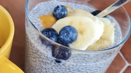 Glass of chia seeds, sliced banana, grapes and coffee cup. Breakfast in Ibiza island. # Holiday. 16 july 2023