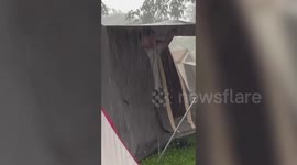 Stranded campers hold onto tent as thunderstorm spoils outdoor fun