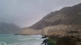 Children at Al Mughsail Blowholes feel the pressure of  water flowing to the seashore through the blowholes