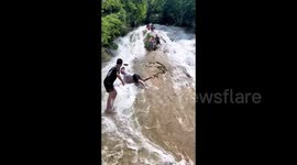 Tourist miraculously escapes serious injuries after dramatic waterfall tumble in central China