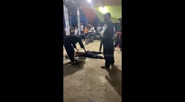 The man lay on the shards of glass and let the motorbike and the four men above run through his stomach