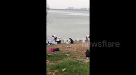 Chinese residents pour bottled water into reservoir for blessing ritual