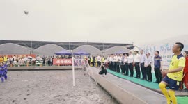 Players slip and slide during 'swamp soccer' event held in Shanghai