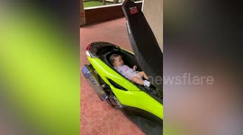 Father uses motorcycle as a cradle to rock baby to sleep