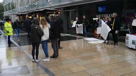 A Just Stop Oil protestor takes one of Piers Corbyns leaflets. This was done outside the Royal Festival Hall where Greta Thunberg was speaking at an event called Greta Thunberg: The Climate Event