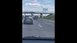Fearless driver defies odds: nonchalantly navigates car on swaying tow track through Minsk's road