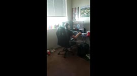 Cat Lays on His Back Under the Bed While Son Games