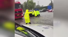 Police help people affected by typhoon-induced rainfall in N China