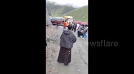People Join Forces in Unison to Pull the Large Truck in Tibet, China