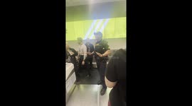 VIDEO SHOWS how a traveller was pinned down by police officers after an airport altercation got out of control.