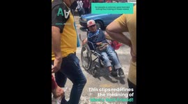 Service dog assists man in wheelchair crossing the street