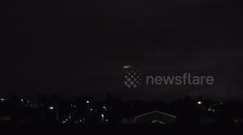 The August Full Moon known as the Sturgeon Moon attempts to appear through the thick cloud with little success.