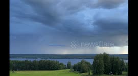 Group of cranes fleeing an incoming storm just before lightning strikes