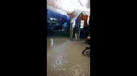 Many customers still continue to eat at the restaurant despite heavy rain and flood water is flooding the restaurant