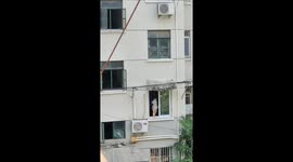 Terrifying scene as young boy walks along narrow 1st-floor window ledge in China