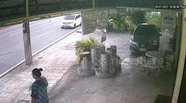 Flying wheel nearly misses woman standing outside shop