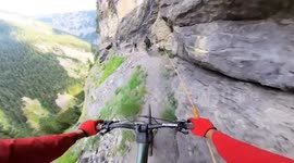 'Insane!' Nail-biting footage of biker speeding along 1,000-feet-high death drop nicknamed the knife edge