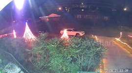 Driver Plows into Parked Car and Christmas Lights (ID: 310925042)