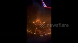 Devastating wildfires captured from airplane flying over Maui