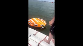 Man takes an unexpected splash as prankish friends pull away the tube at the last moment